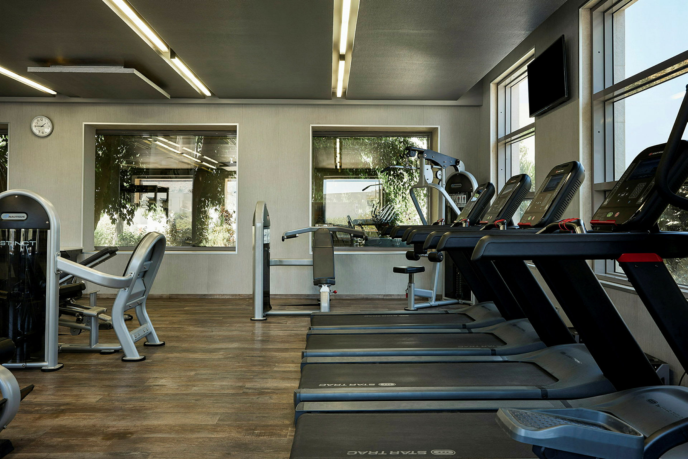 Fitnesscenter med træningsmaskiner og løbebånd. (AI-genereret tekst)