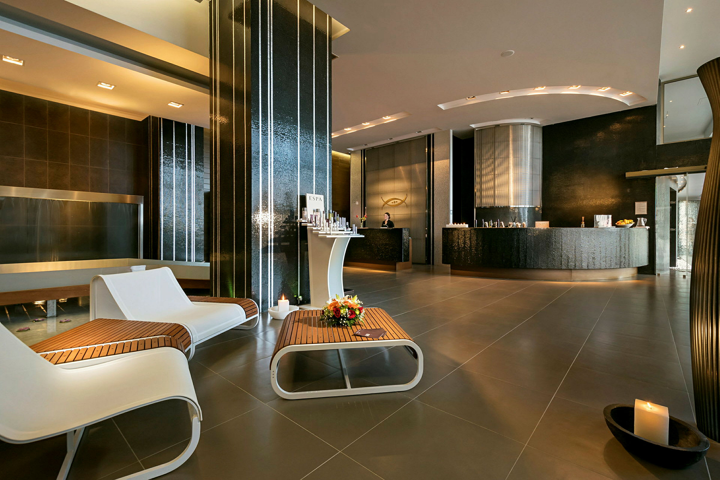 Lobbyområde med moderne indretning, siddepladser og reception. (AI-genereret tekst)