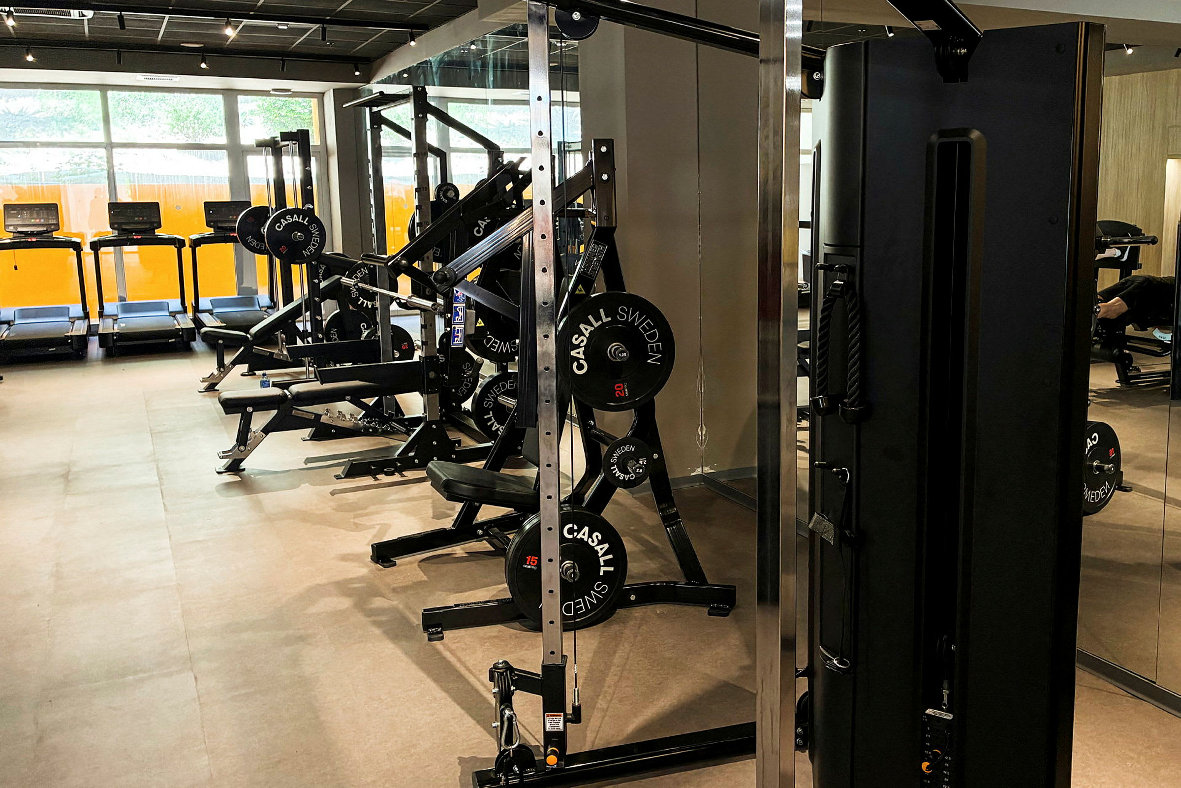 Et fitnesscenter med træningsmaskiner, løbebånd og andet træningsudstyr. (AI-genereret tekst)