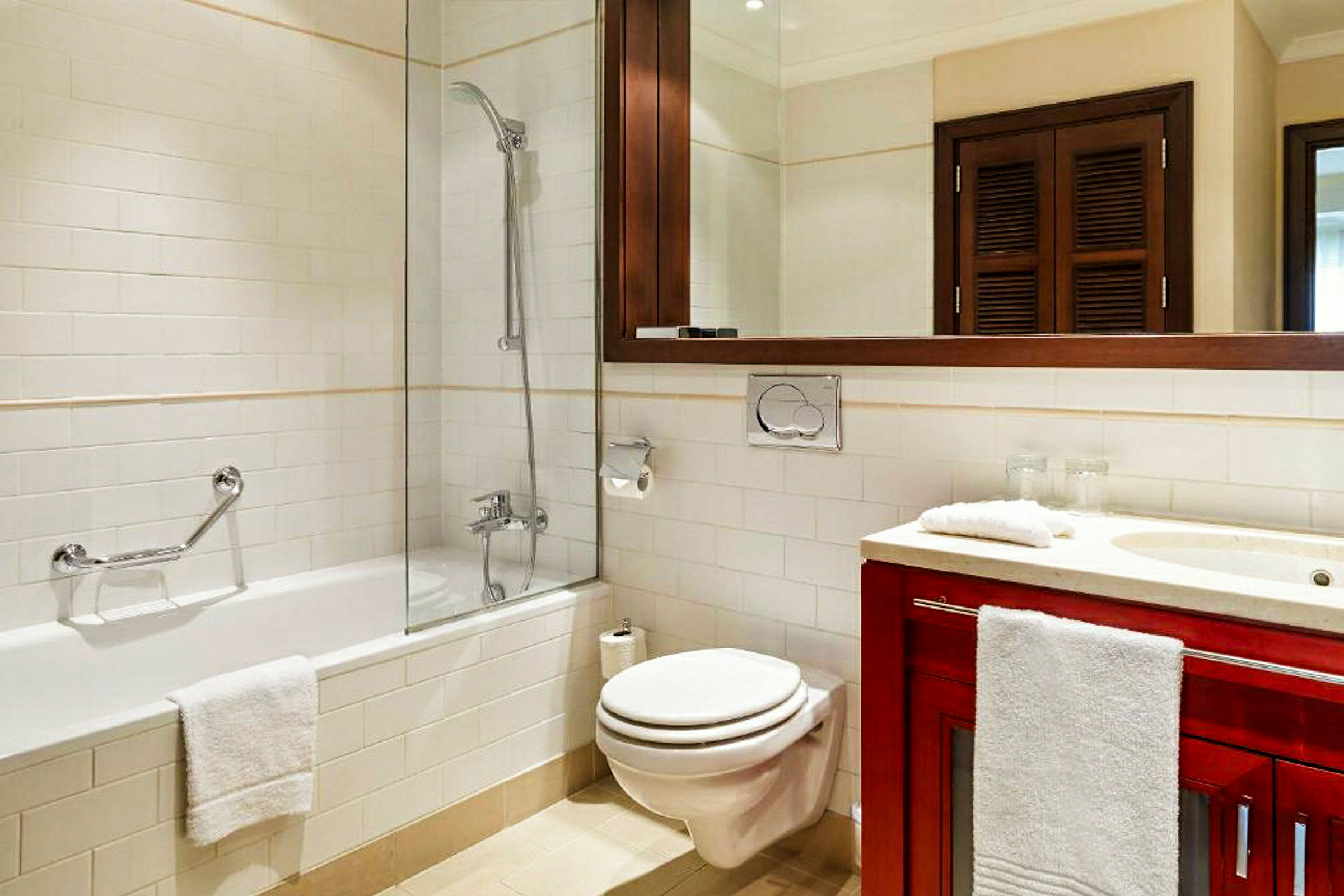 Et badeværelse med badekar, toilet og håndvask. (AI-genereret tekst)