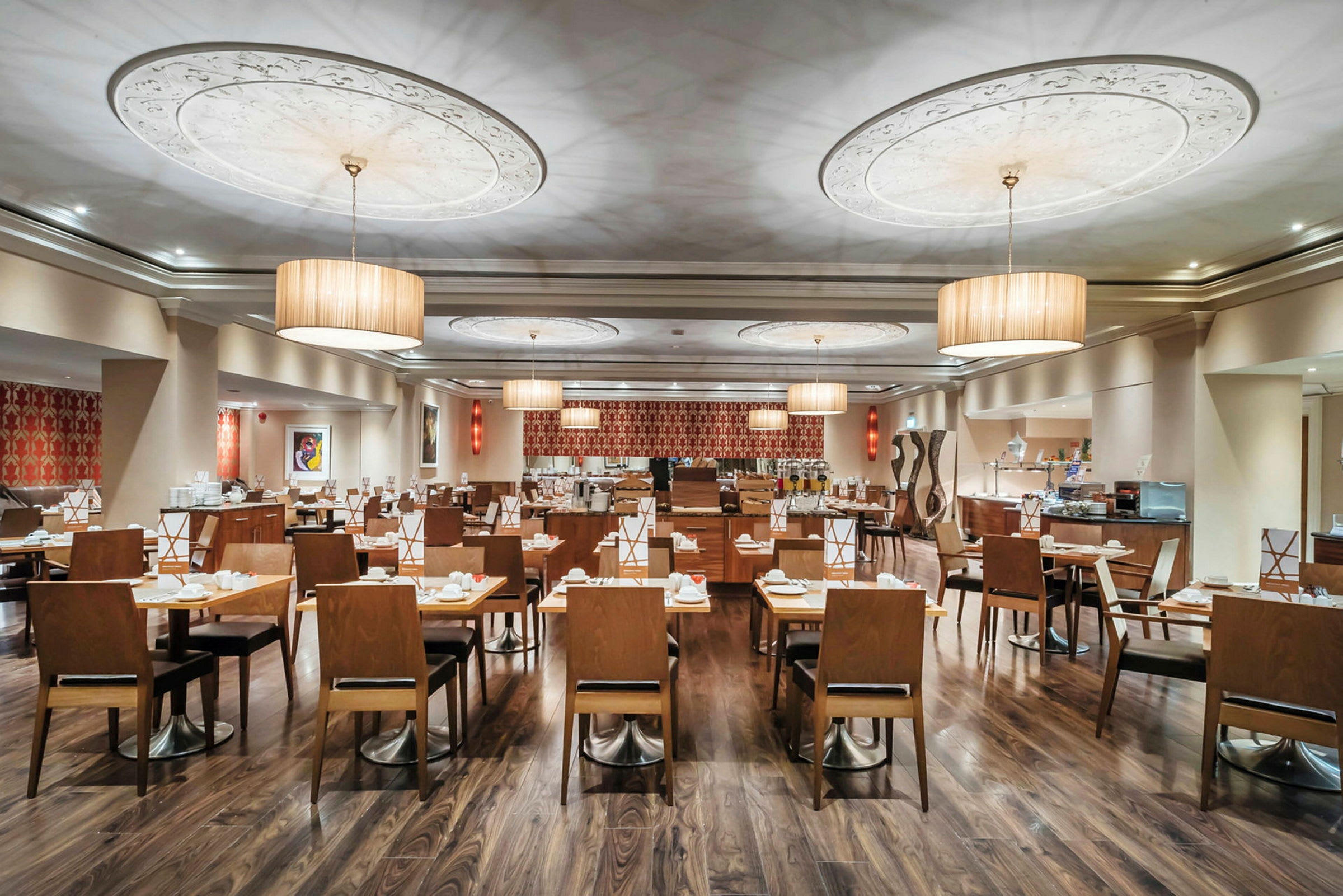Restaurant med oplyst træudsmykning og dækkede borde. (AI-genereret tekst)