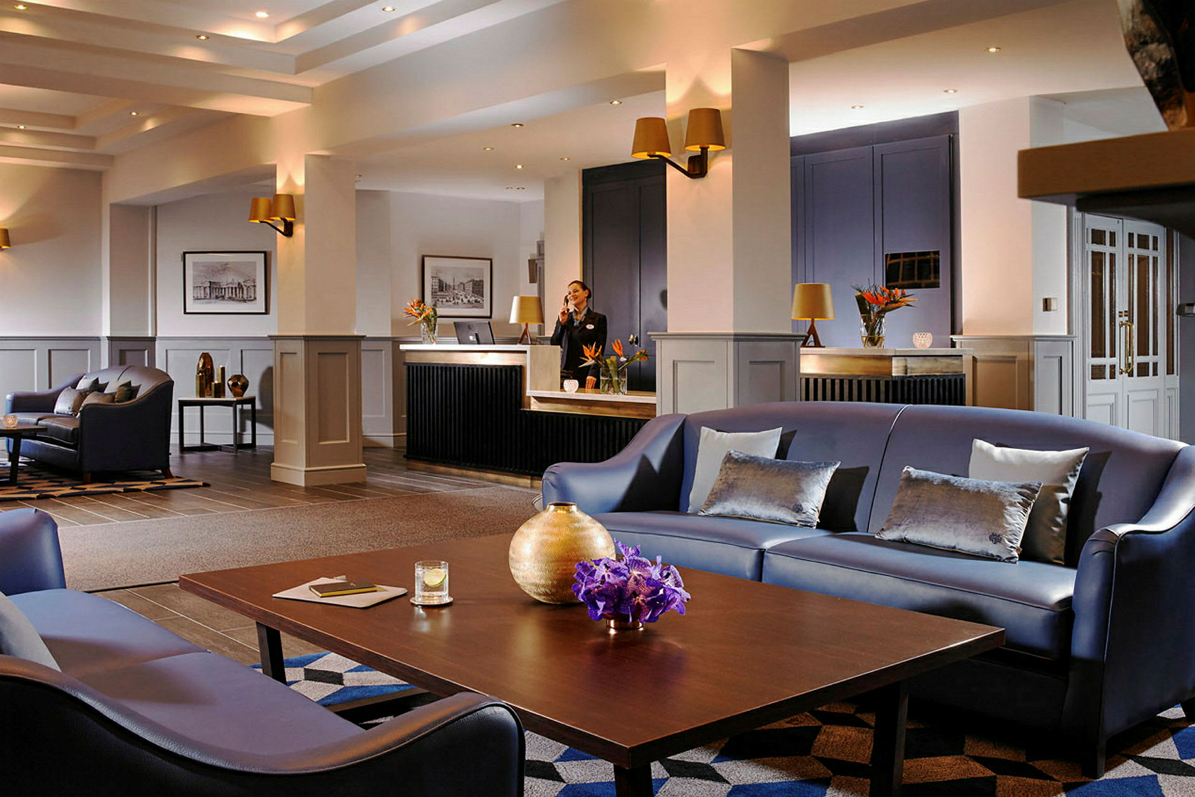 En moderne hotellobby med sofaer, borde og reception. (AI-genereret tekst)