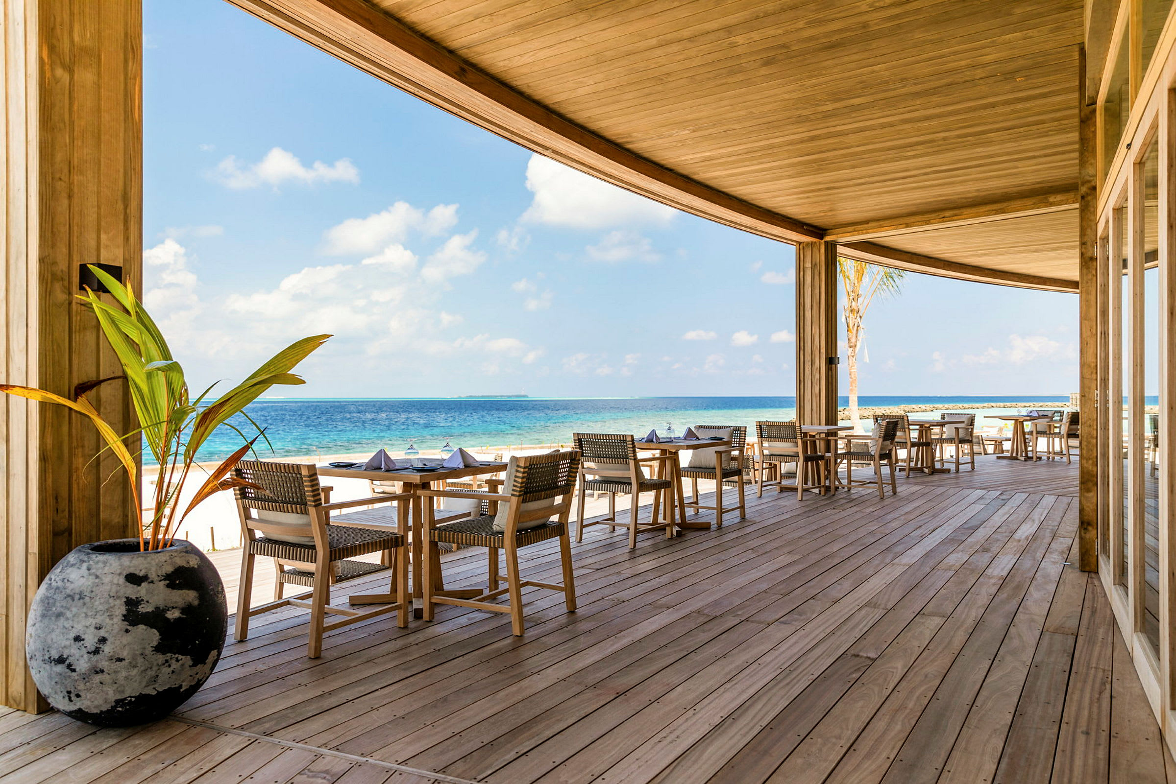 Udendørs restaurant på en veranda med udsigt over havet. (AI-genereret tekst)