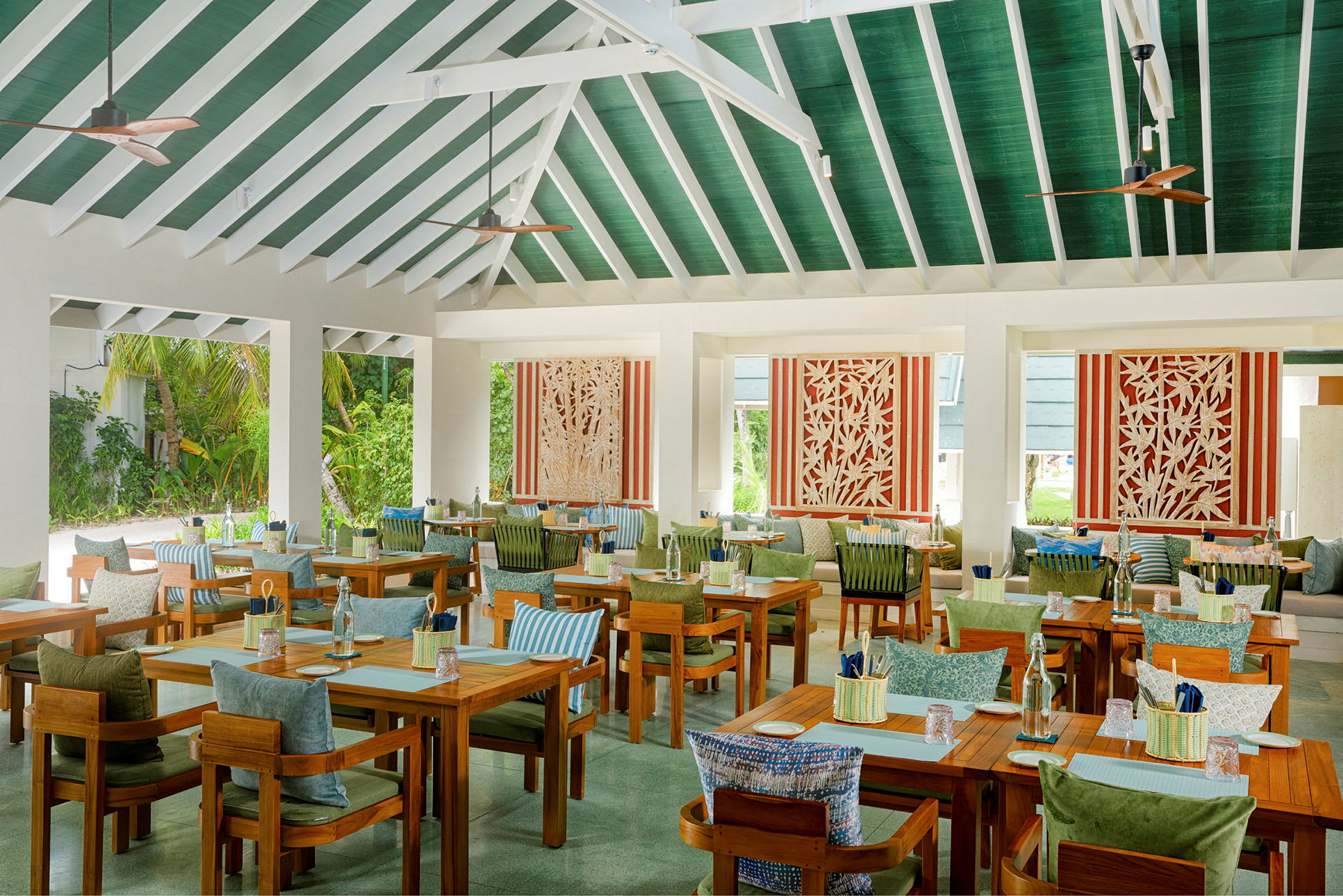 Restaurant med træborde, grønne detaljer og dekorative paneler. (AI-genereret tekst)
