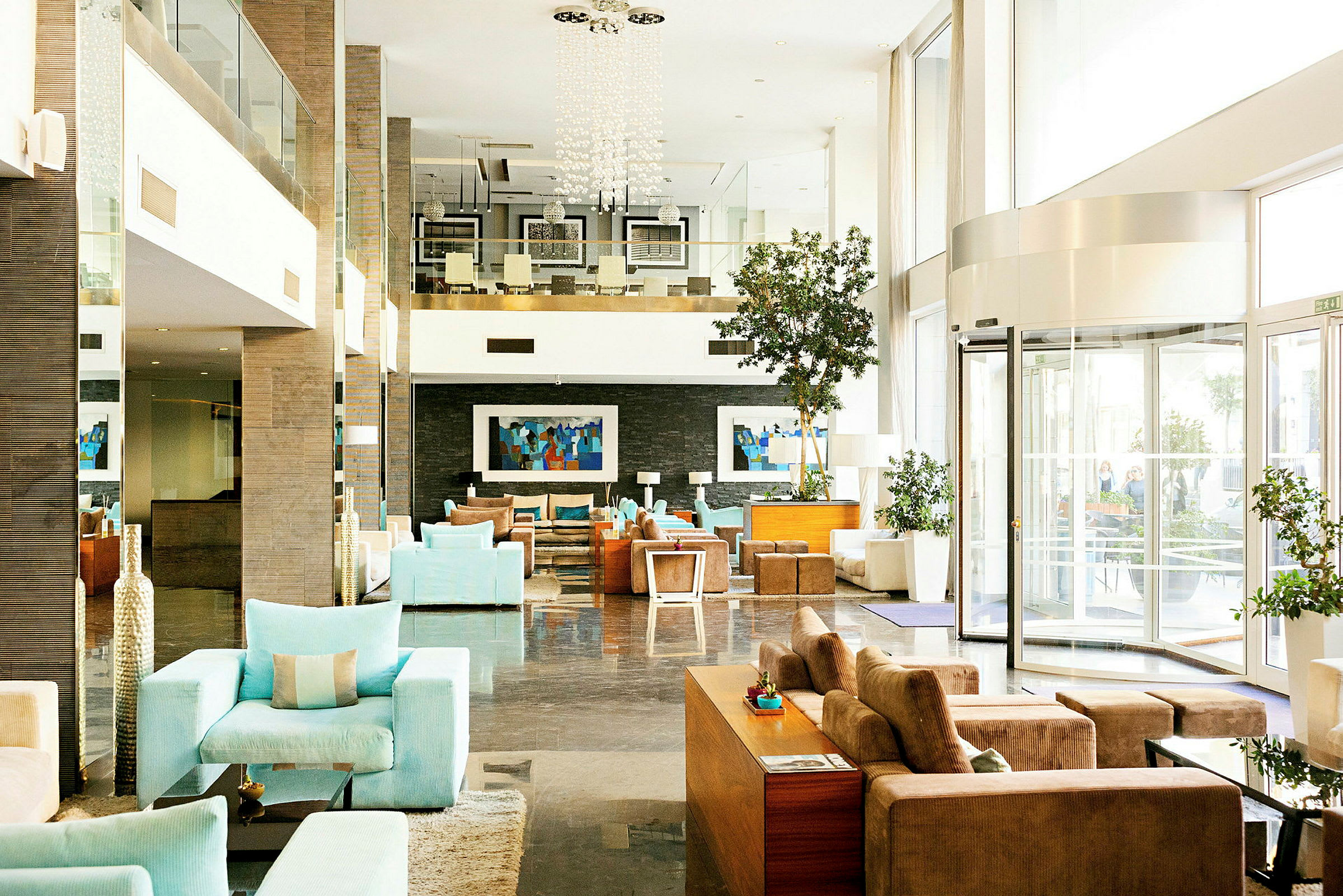 En lys og moderne hotellobby med komfortable siddearrangementer og dekorative detaljer. (AI-genereret tekst)