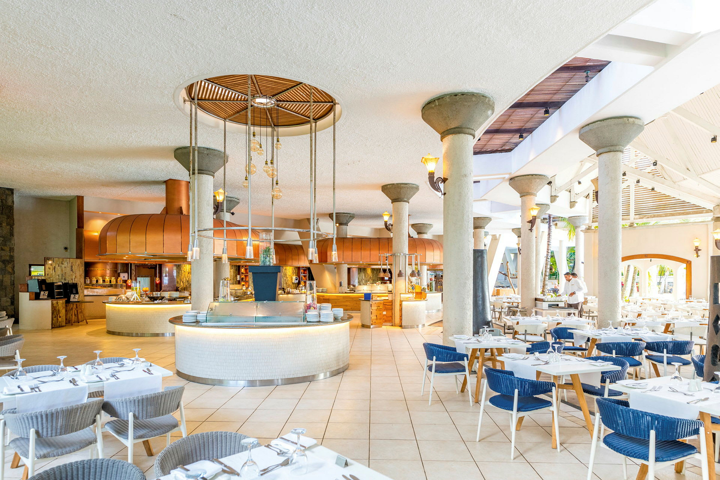 Billede af en restaurant med dækkede borde og et åbent køkkenområde. (AI-genereret tekst)