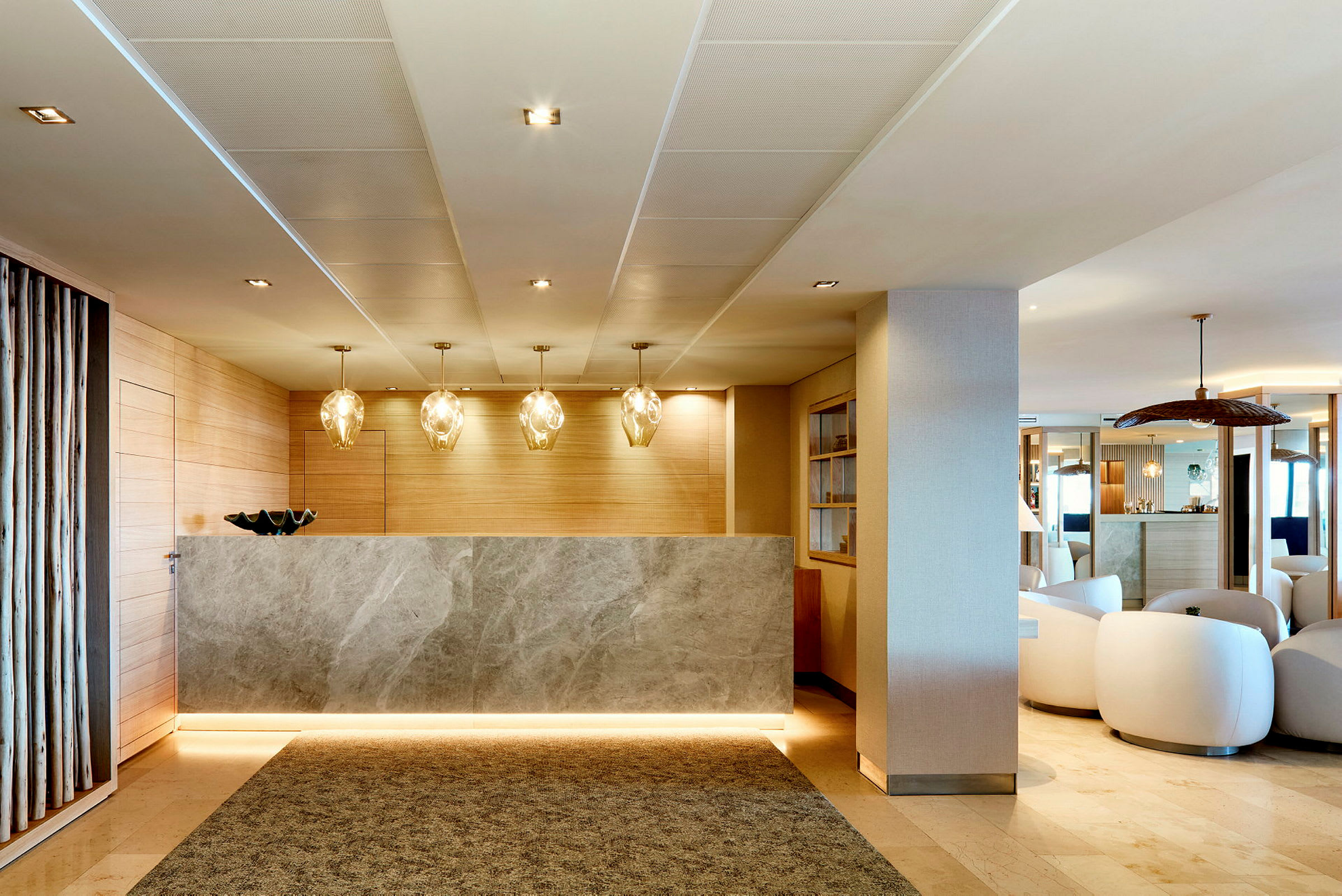Hotelreception med marmordisk og belysning. (AI-genereret tekst)