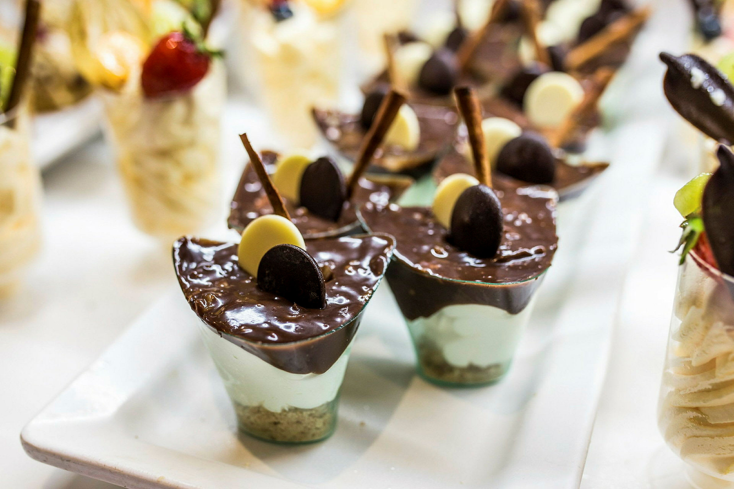 Små dessertglas med chokolademousse og dekorationer. (AI-genereret tekst)
