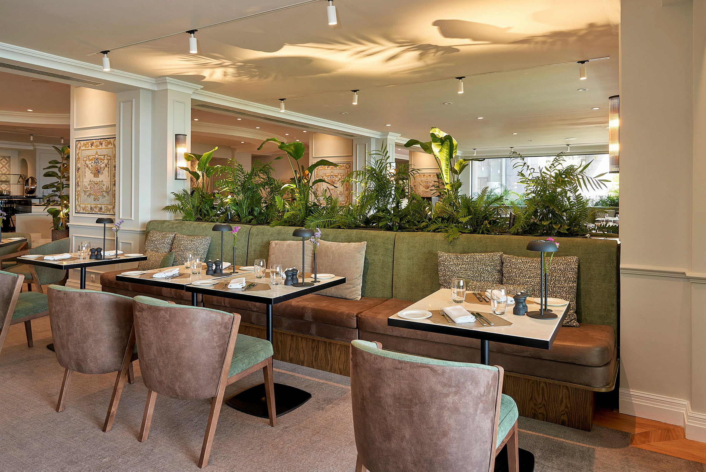Billede af en moderne restaurant med siddegrupper omkring små borde. (AI-genereret tekst)