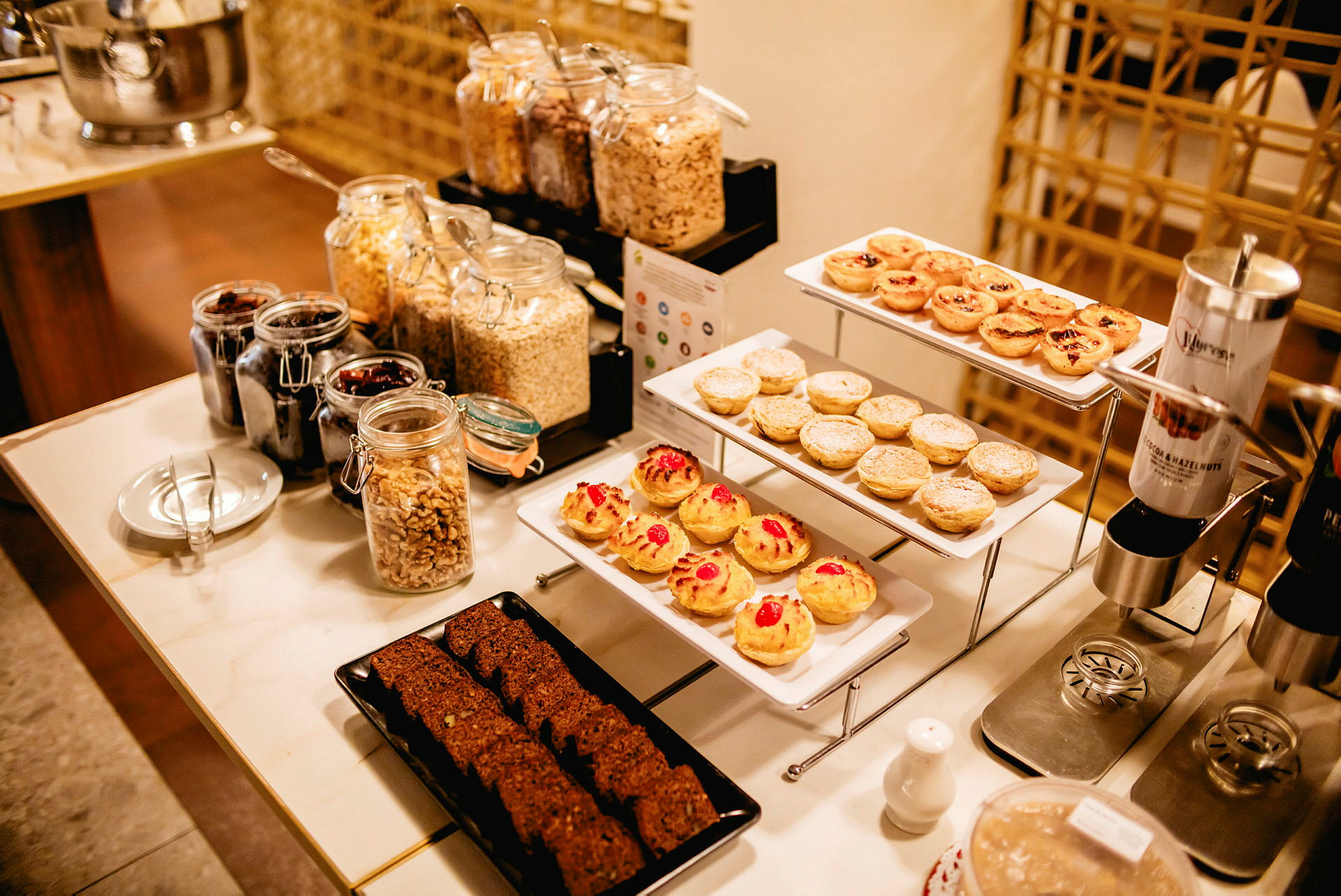 En morgenbuffet med bagværk, frugt og korn. (AI-genereret tekst)