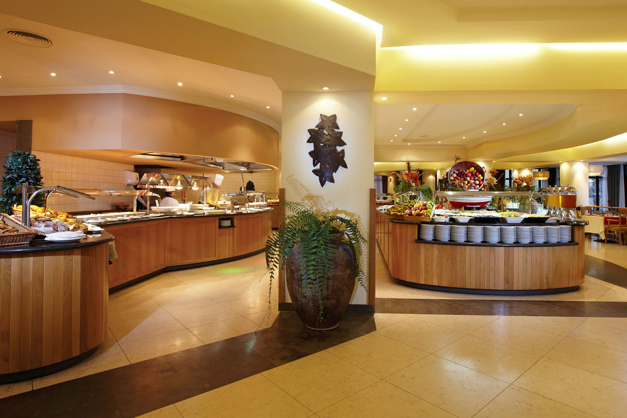 En buffet i en restaurant med flere madstationer og et stort udvalg af retter. (AI-genereret tekst)