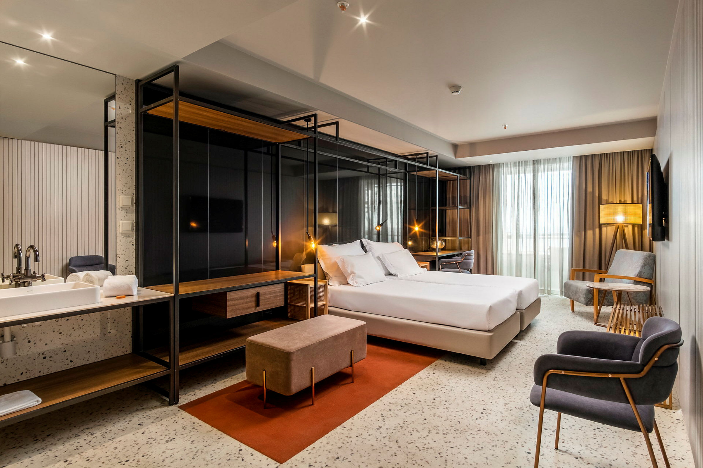 Moderne hotelværelse med dobbeltseng, siddeområde og skrivebord. (AI-genereret tekst)