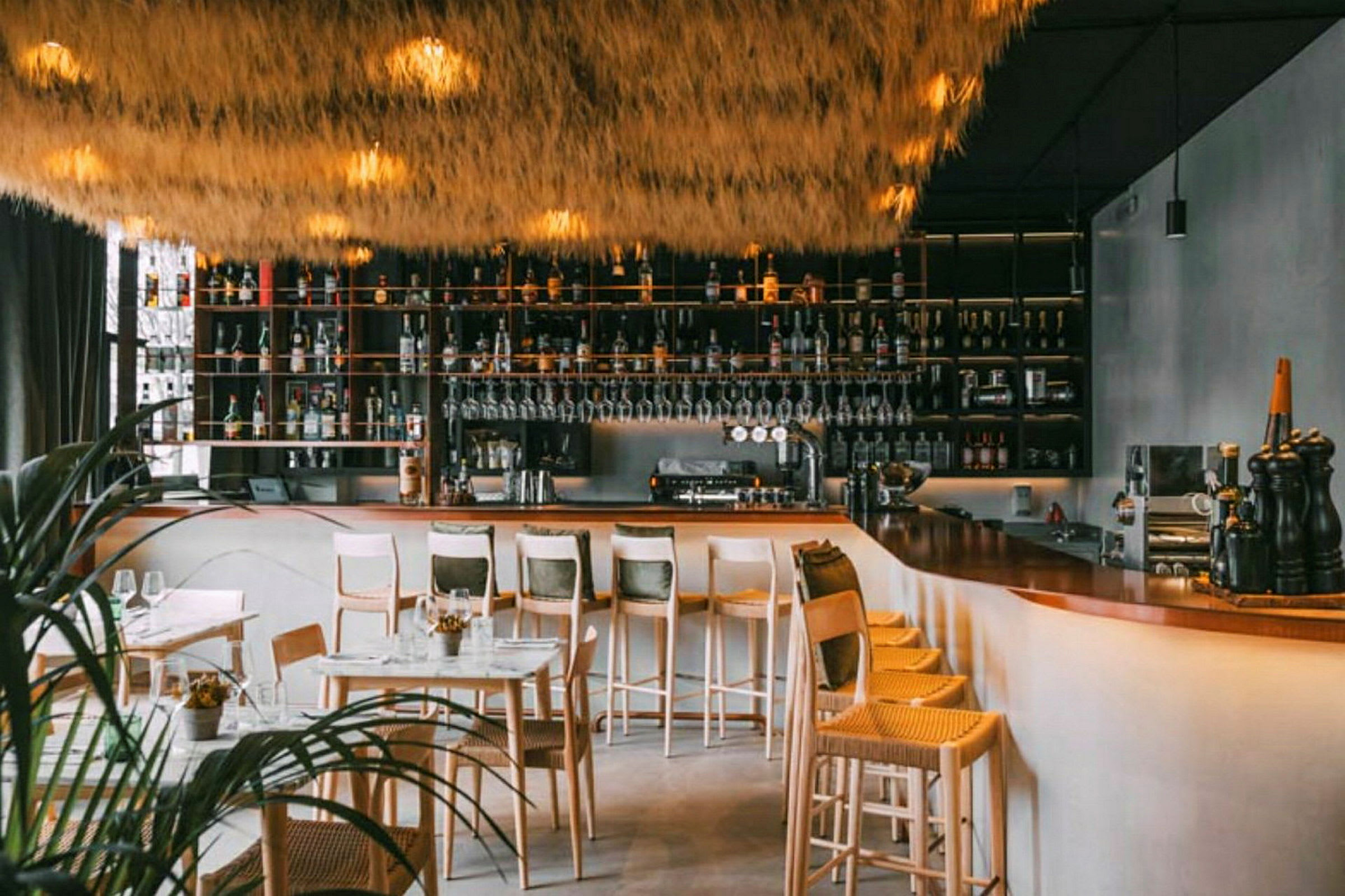 En moderne bar med højt til loftet og elegant indretning. (AI-genereret tekst)