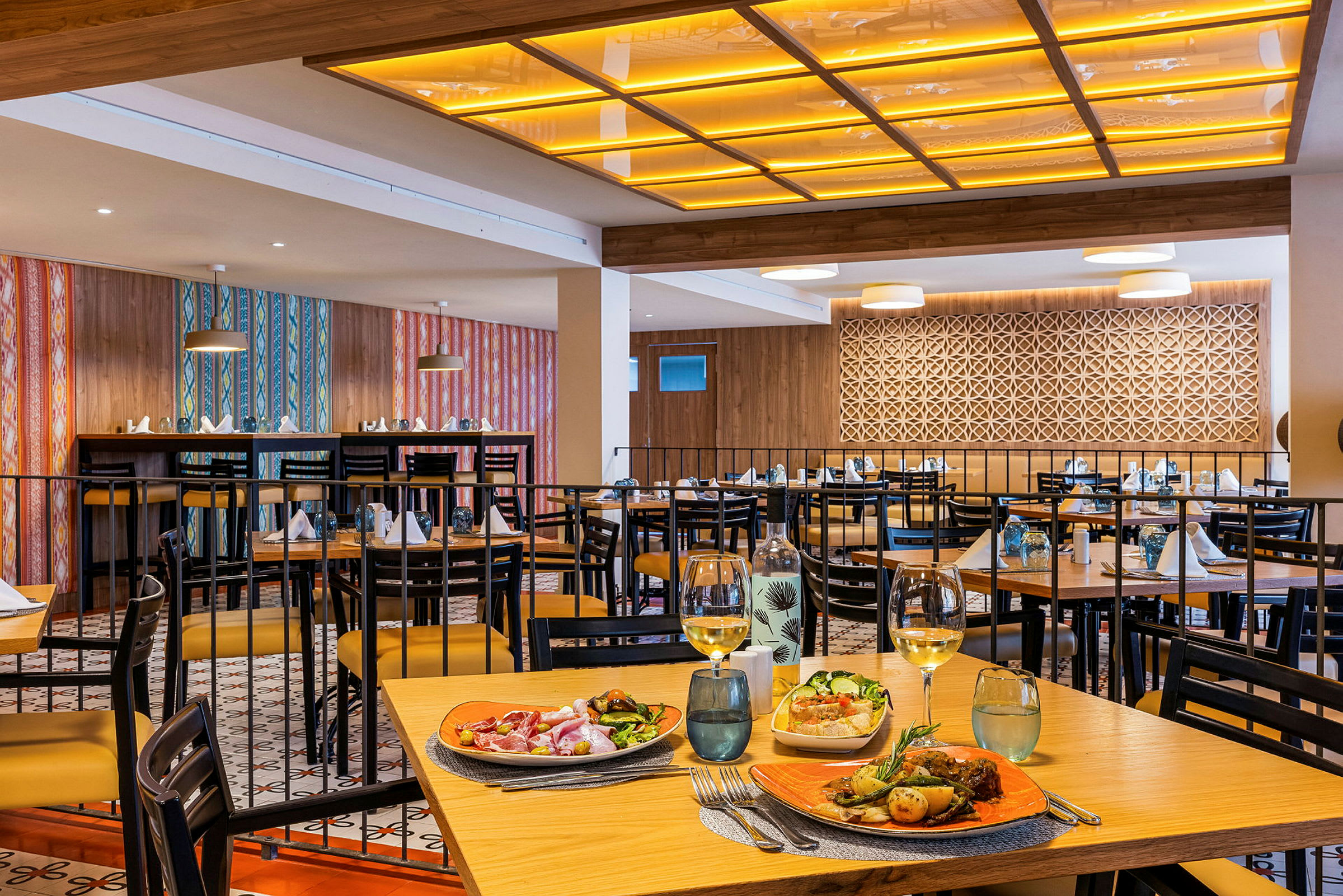 Restaurant med dækkede borde og mad serveret på et af dem. (AI-genereret tekst)