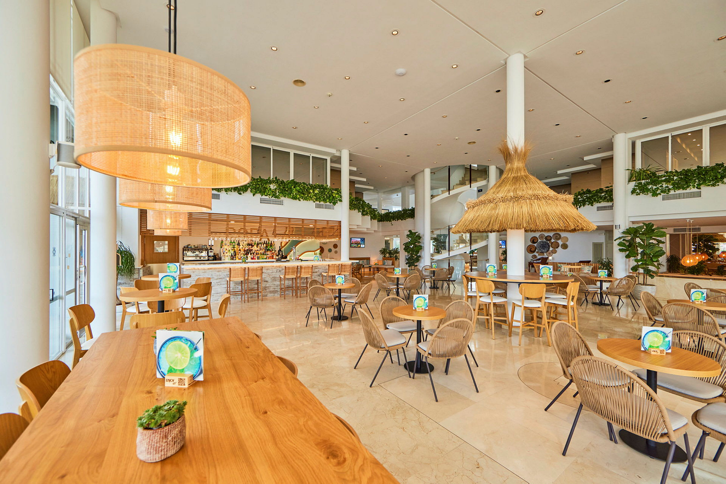 En moderne og lys cafeteria med borde og stole arrangeret i et rummeligt område. (AI-genereret tekst)