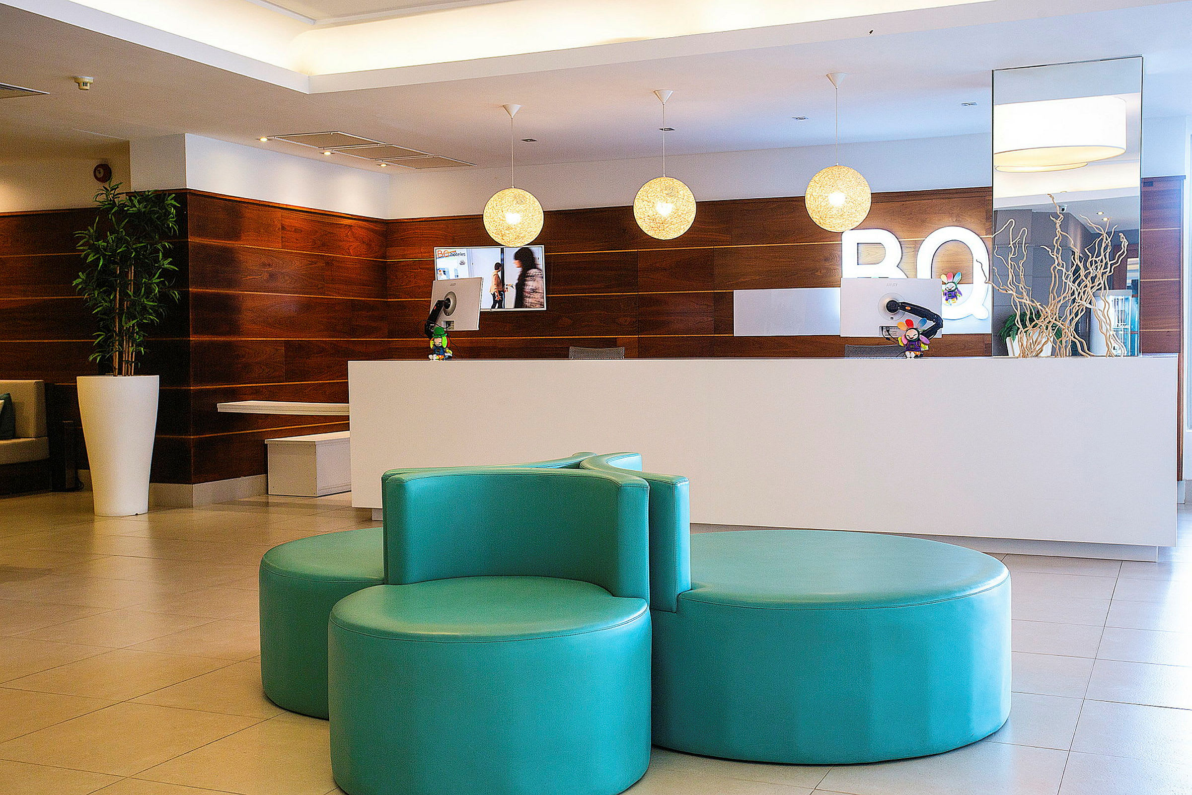 Hotelreception med hvid skranke og moderne design. (AI-genereret tekst)