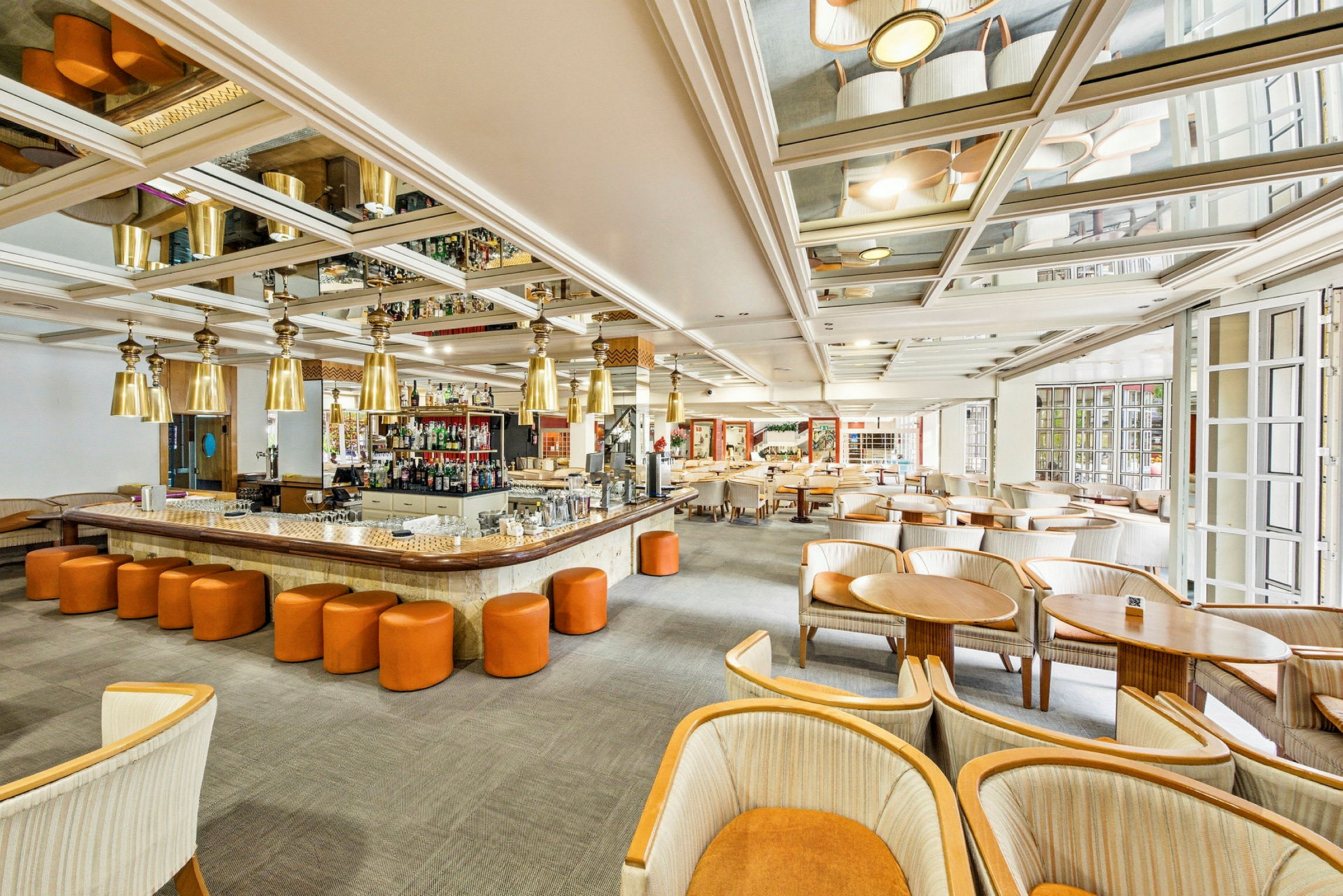 Billede af en lys og rummelig bar og lounge med moderne møbler og en central bardisk. (AI-genereret tekst)