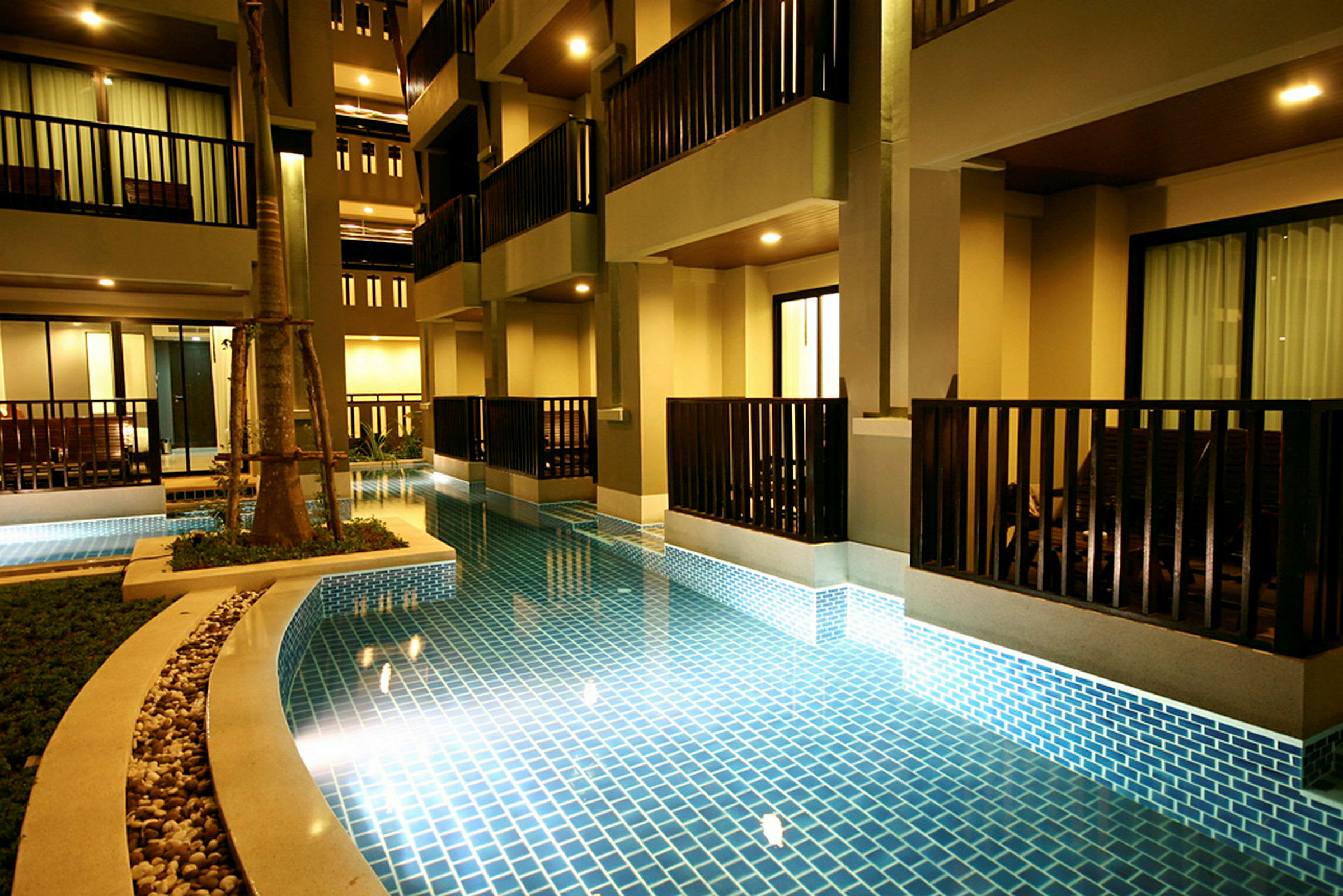 Udendørsområde ved pool med altaner. (AI-genereret tekst)