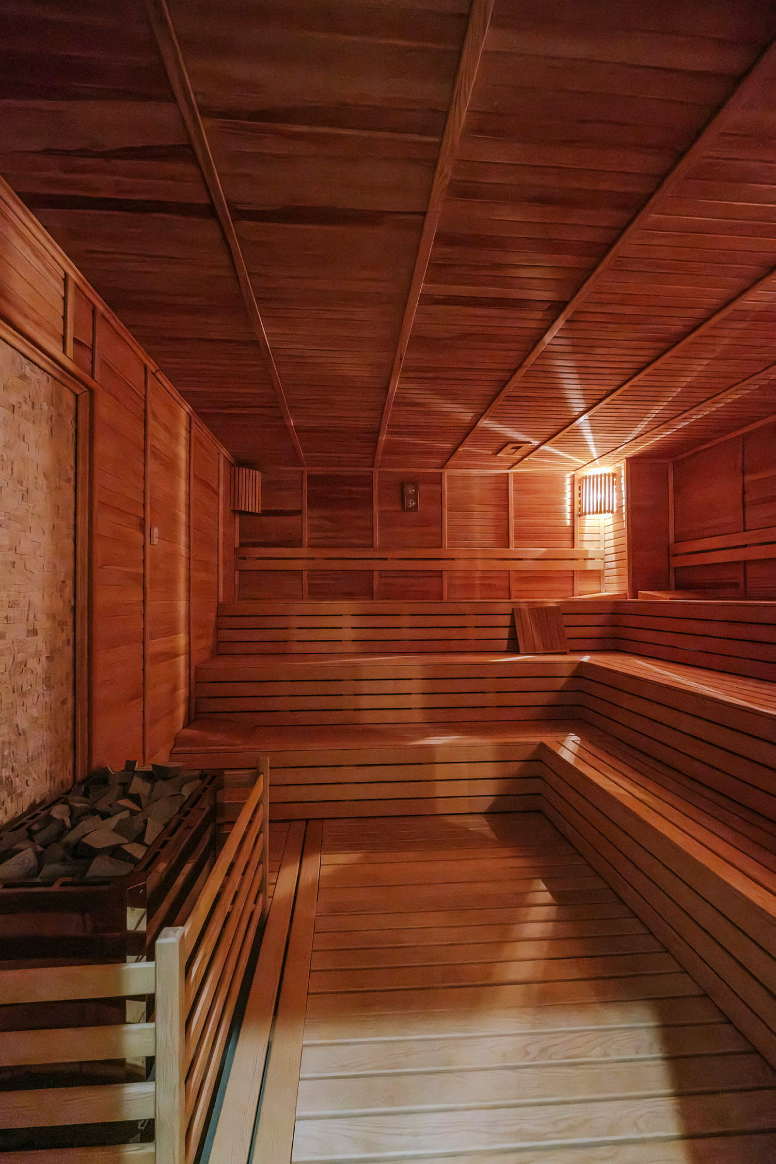 Interiør af en sauna med træpaneler og bænke. (AI-genereret tekst)