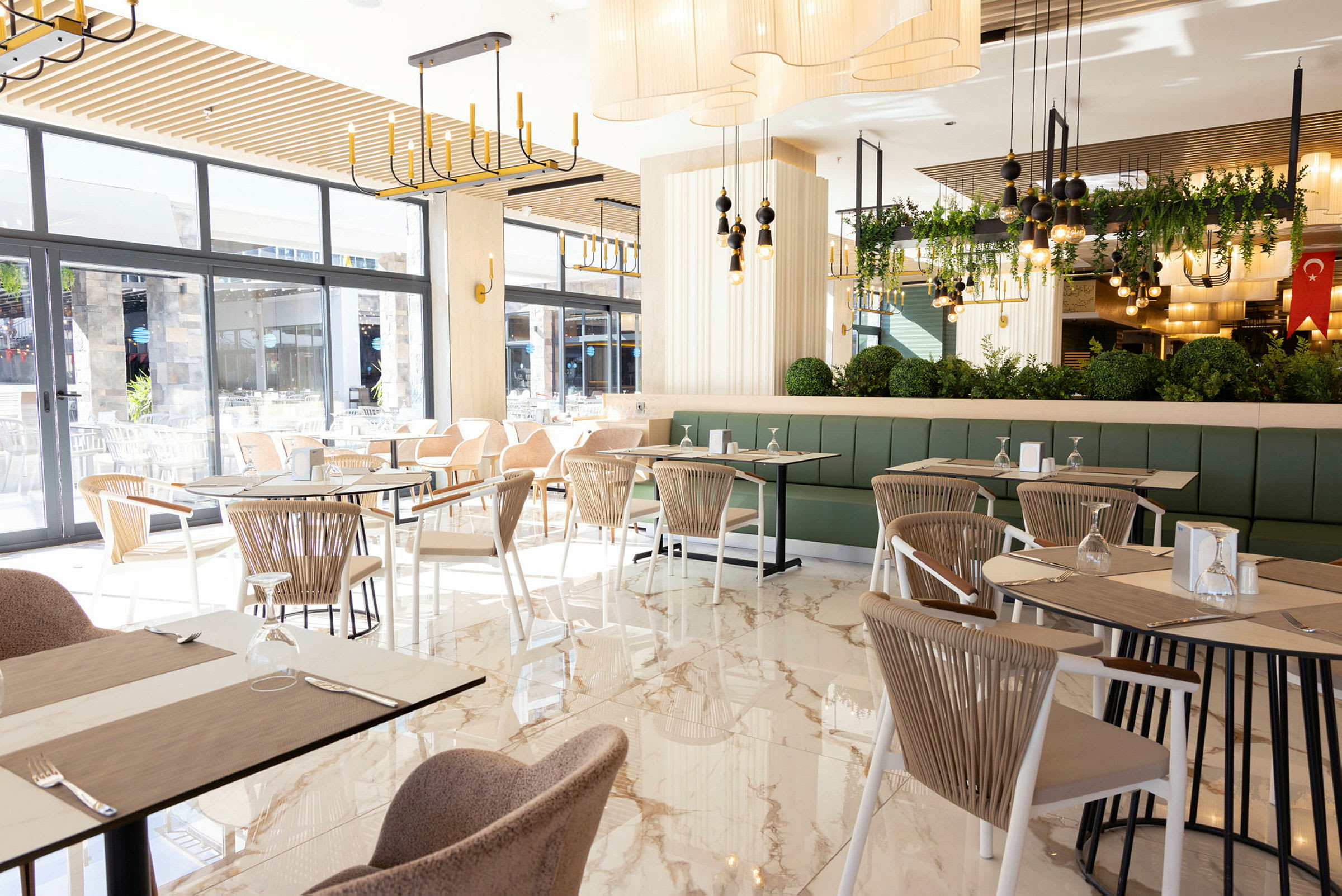 En lys og moderne restaurant med store vinduer og elegant indretning. (AI-genereret tekst)