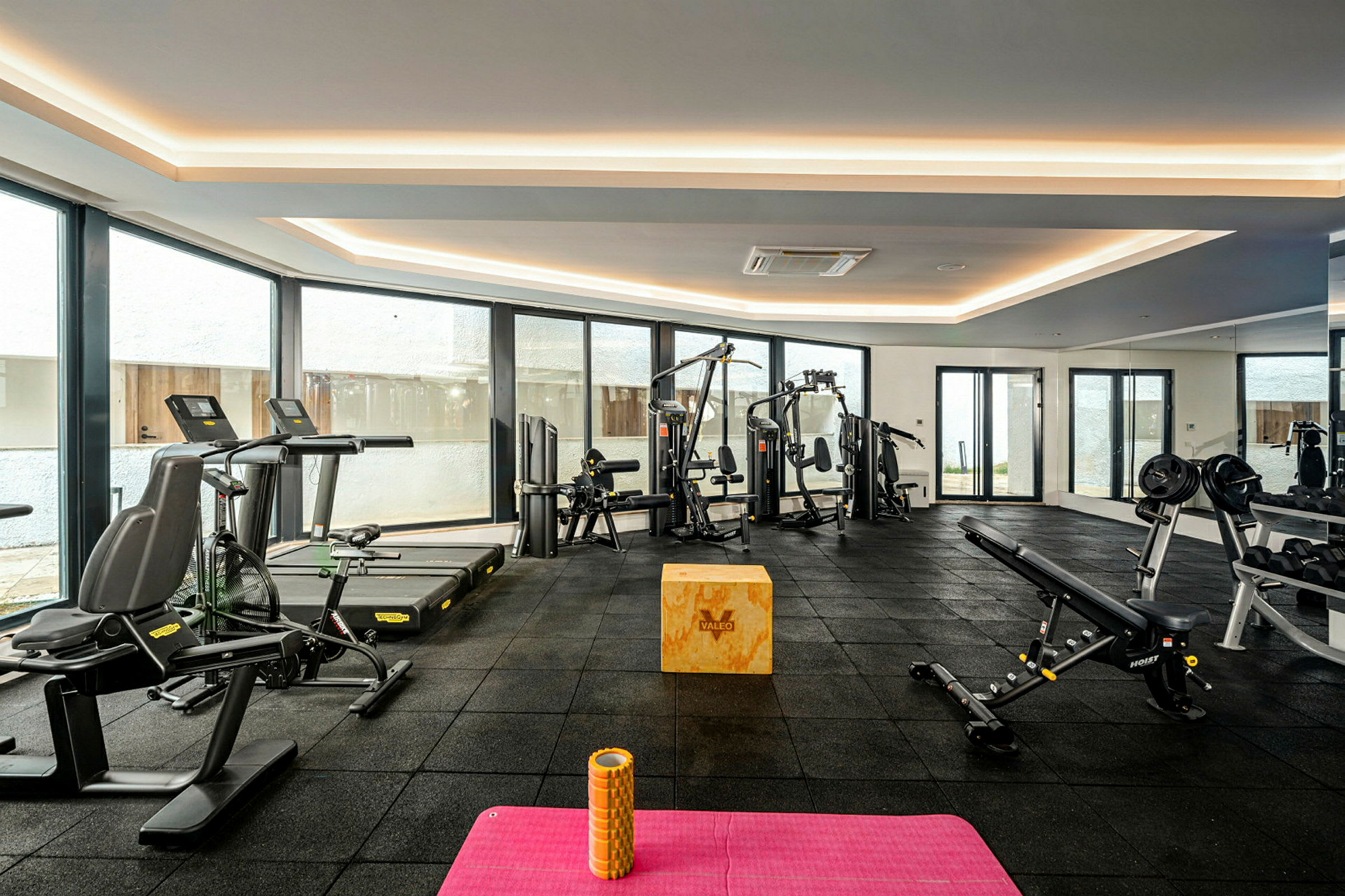 Et fitnesscenter med træningsmaskiner og udstyr. (AI-genereret tekst)