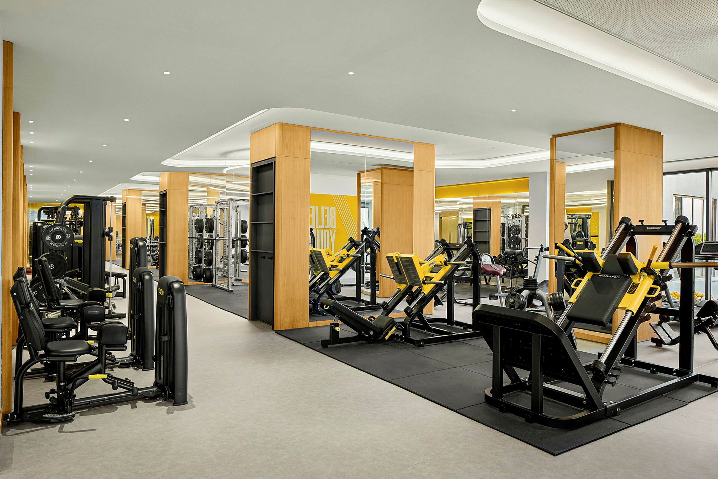 Et moderne fitnesscenter med træningsmaskiner og spejle. (AI-genereret tekst)