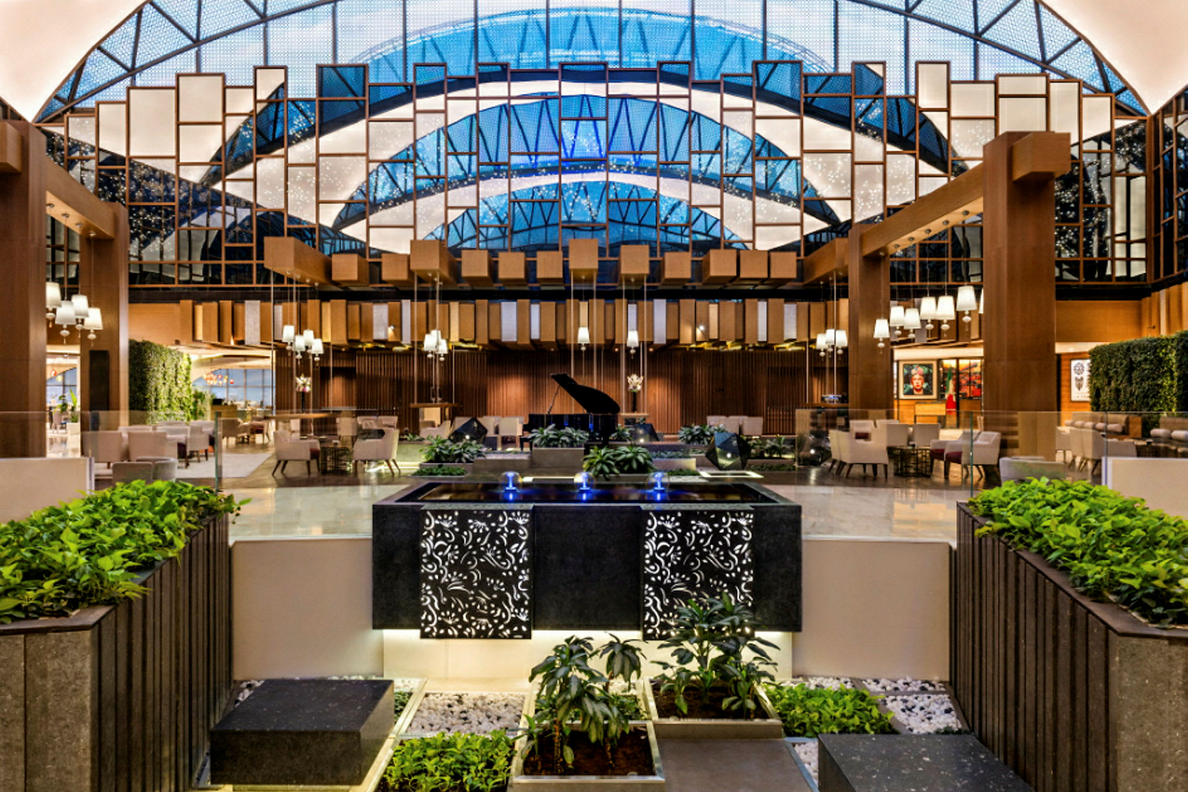 Interiør af en elegant hotellobby med et flygel, siddepladser og dekorativ beplantning. (AI-genereret tekst)