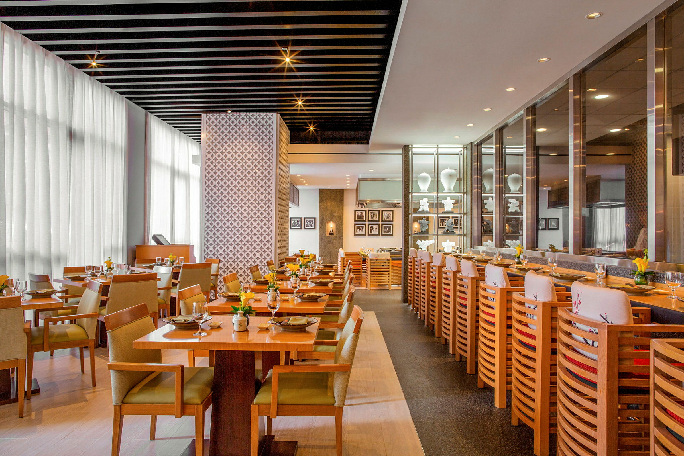 Restaurant med elegant indretning, borde og stole arrangeret til måltider. (AI-genereret tekst)