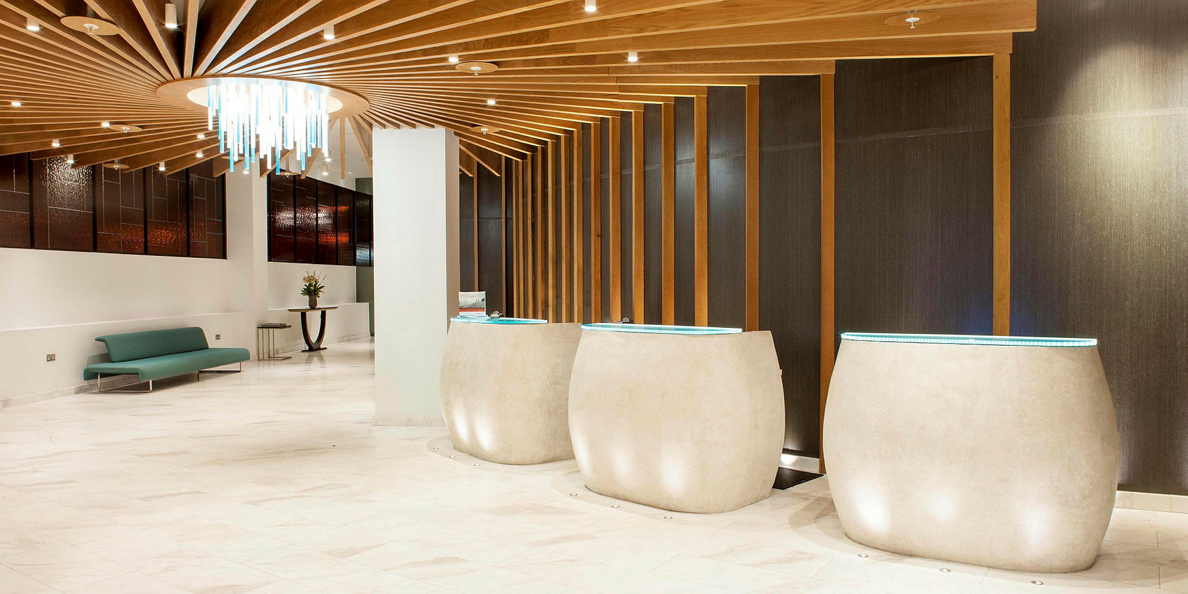 Moderne lobby med lyse gulve, designermøbler og dekorativ lysekrone. (AI-genereret tekst)