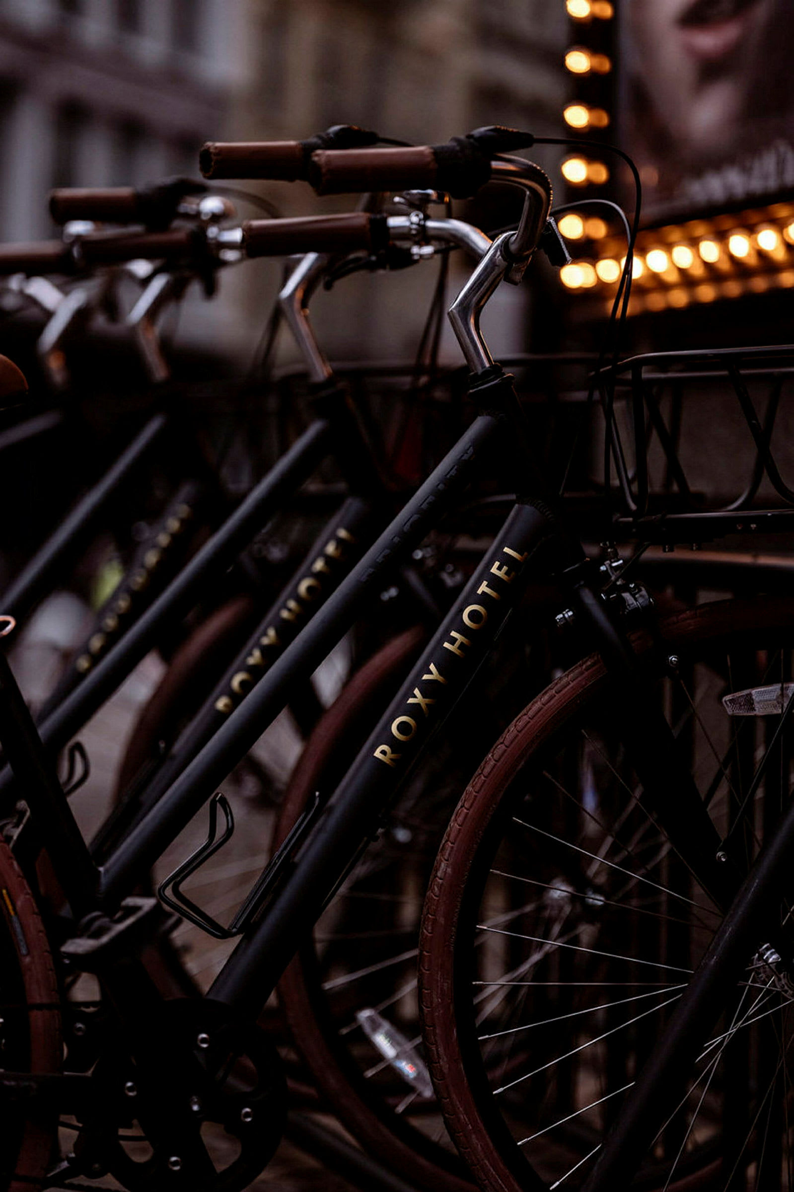 Nærbillede af en række cykler med skiltning for Roxy Hotel. (AI-genereret tekst)