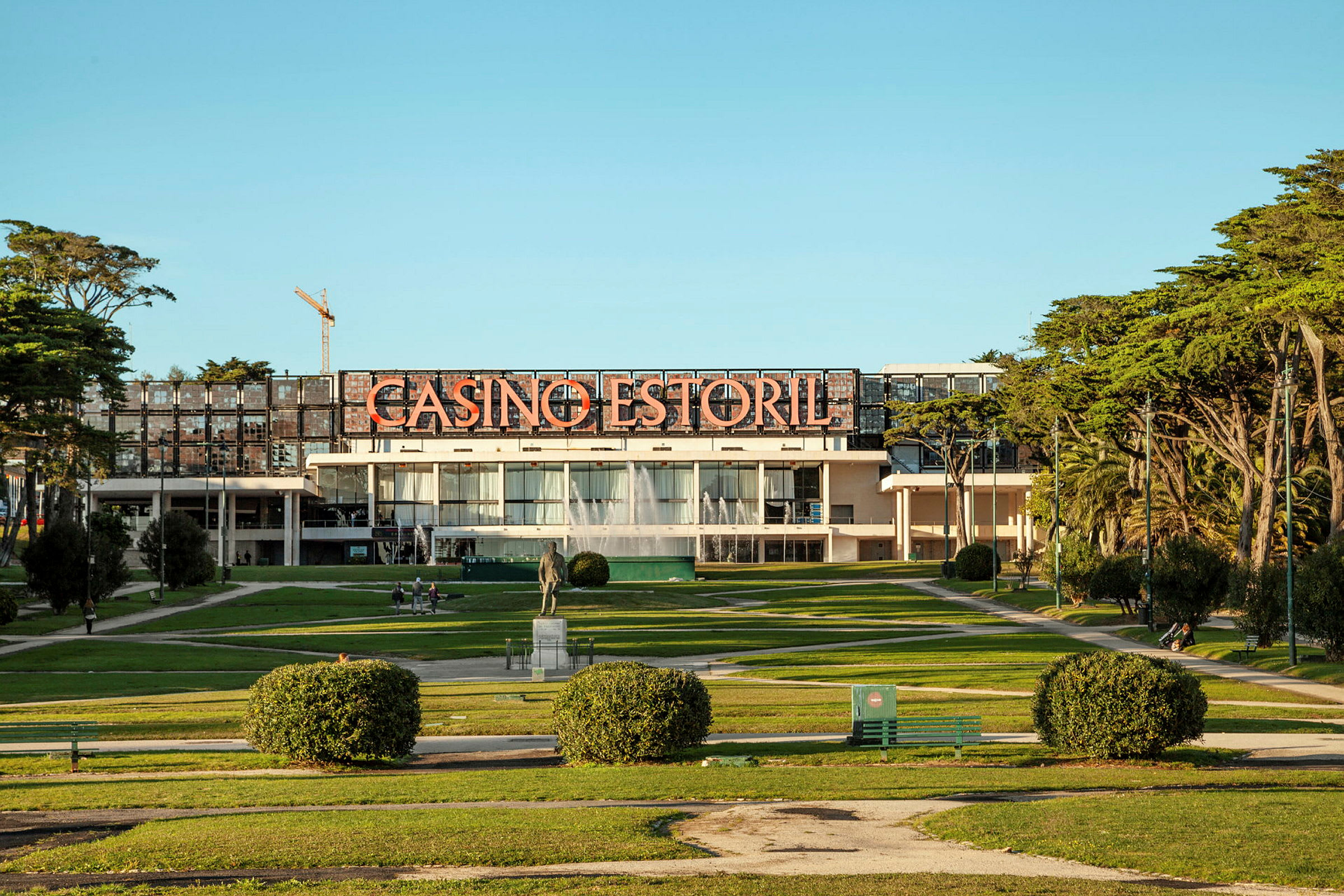 Billede af Casino Estoril, omgivet af grønt og gangstier. (AI-genereret tekst)