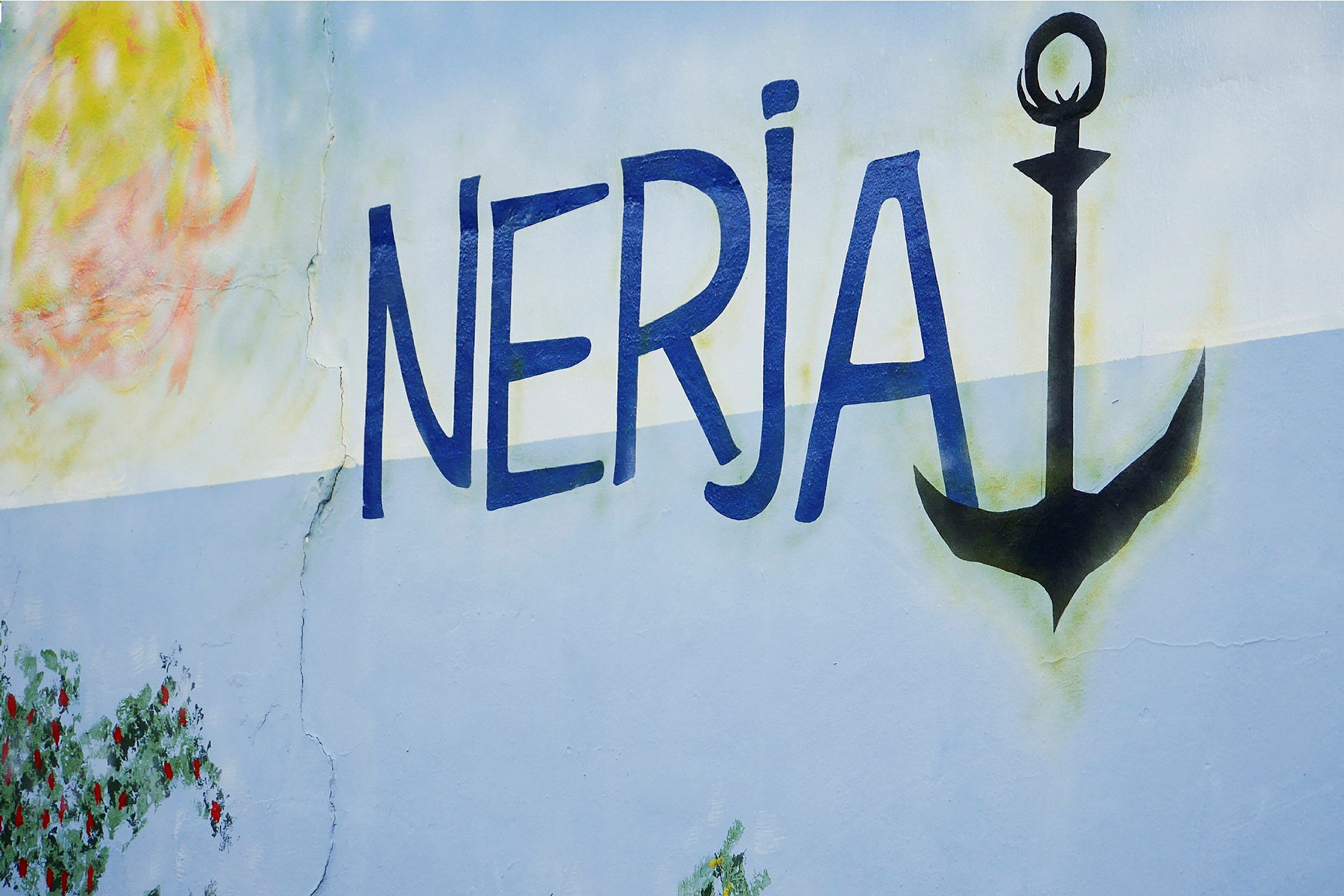 Vægmaleri med teksten 'Nerja' og et sort anker. (AI-genereret tekst)