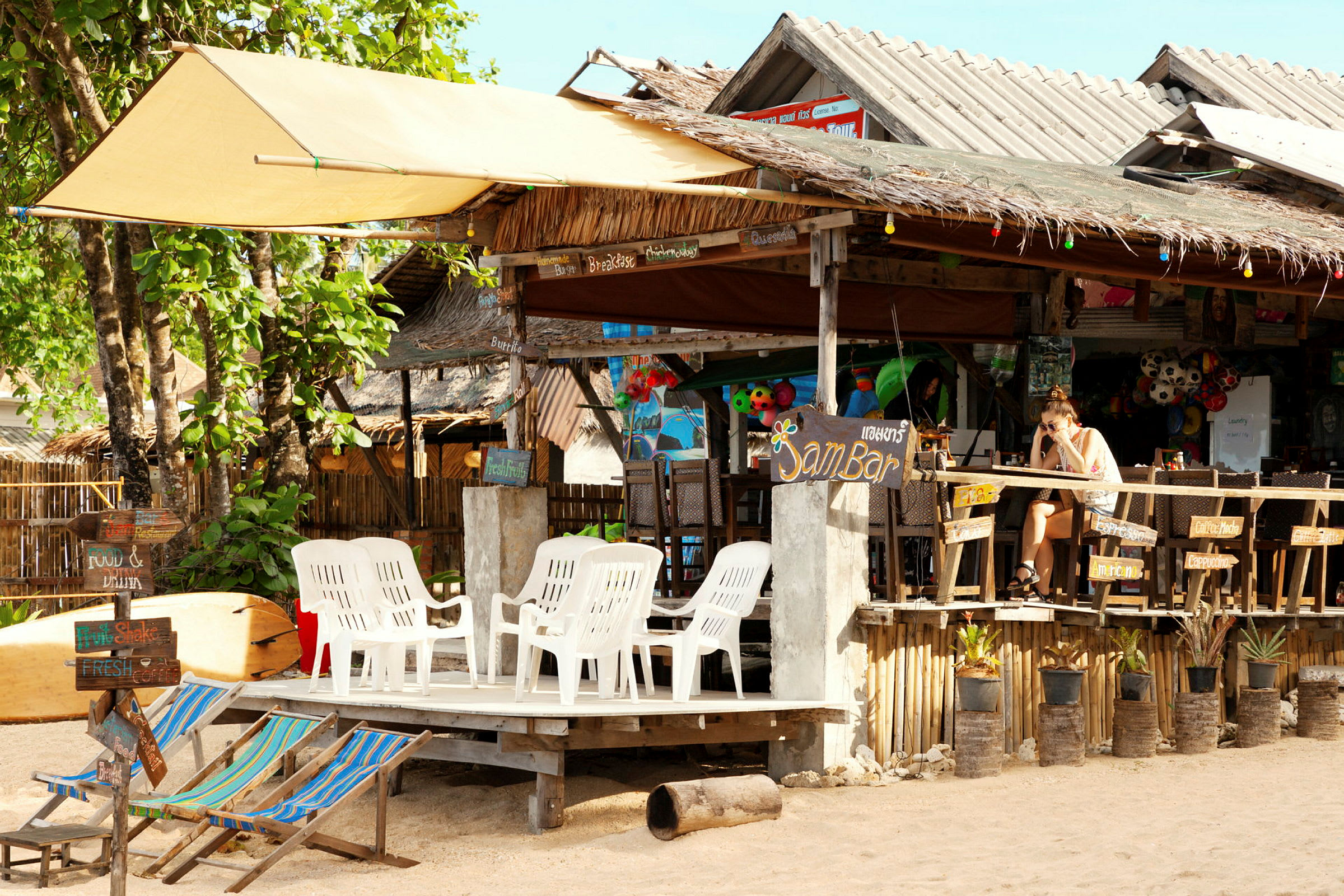 En strandcafé med plastikstole og farverige dekorationer. (AI-genereret tekst)